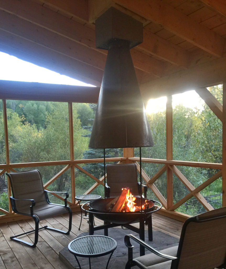 Screened porch with fire place in woods