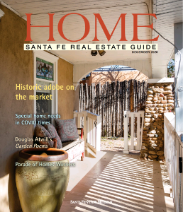 Charming pathway of a historic adobe home in Santa Fe featured in the "HOME" real estate guide, highlighting unique architectural details.