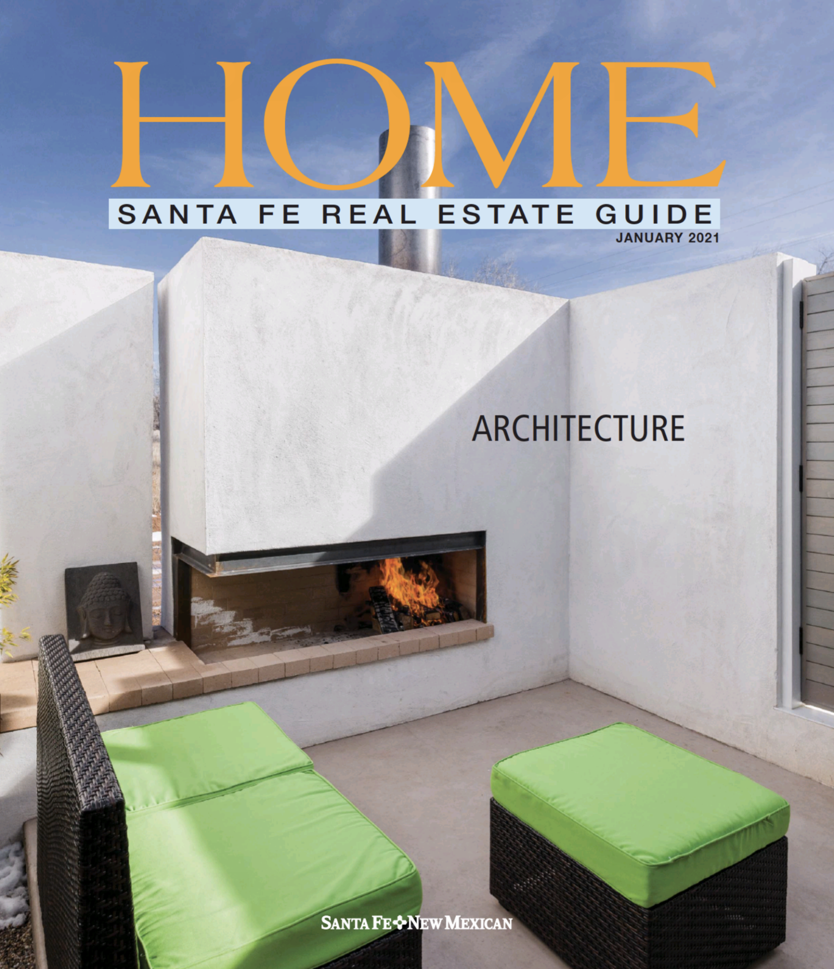 Modern outdoor seating area with a sleek fireplace featured in the "HOME" real estate guide, showcasing contemporary architecture in Santa Fe.