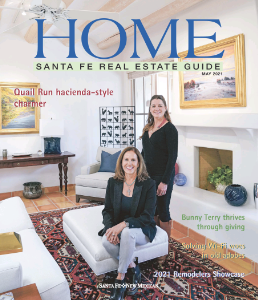 Home Santa Fe Real Estate Guide May 2021 issue featuring a Quail Run hacienda-style home with two women standing by the fireplace.