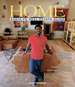 Cover of the Santa Fe Real Estate Guide (September 2020) featuring a man standing in a modern living room, highlighting a property in La Villa Escondida.